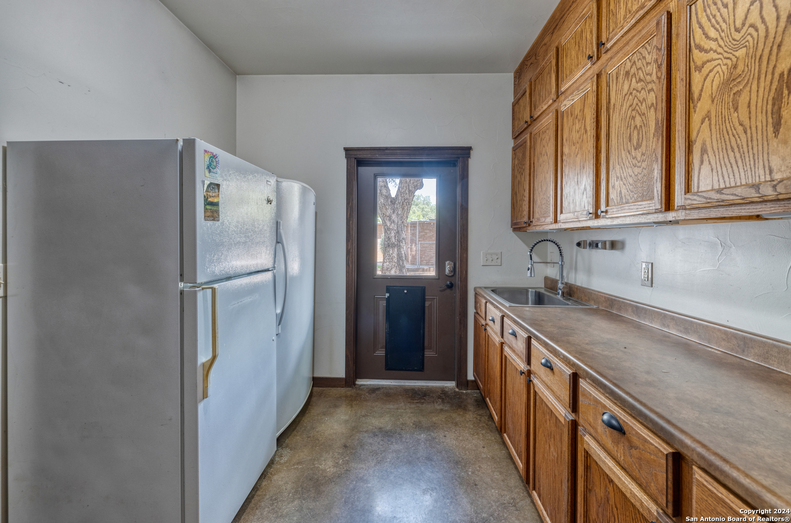 1242 River Road Concan, TX 78838 - Photo 10 of 42 a kitchen with stainless steel appliances granite countertop a refrigerator and a sink