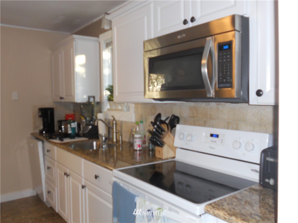 705 North 88th Street Seattle, WA 98103 - Photo 13 of 22 a bathroom with a sink and a mirror