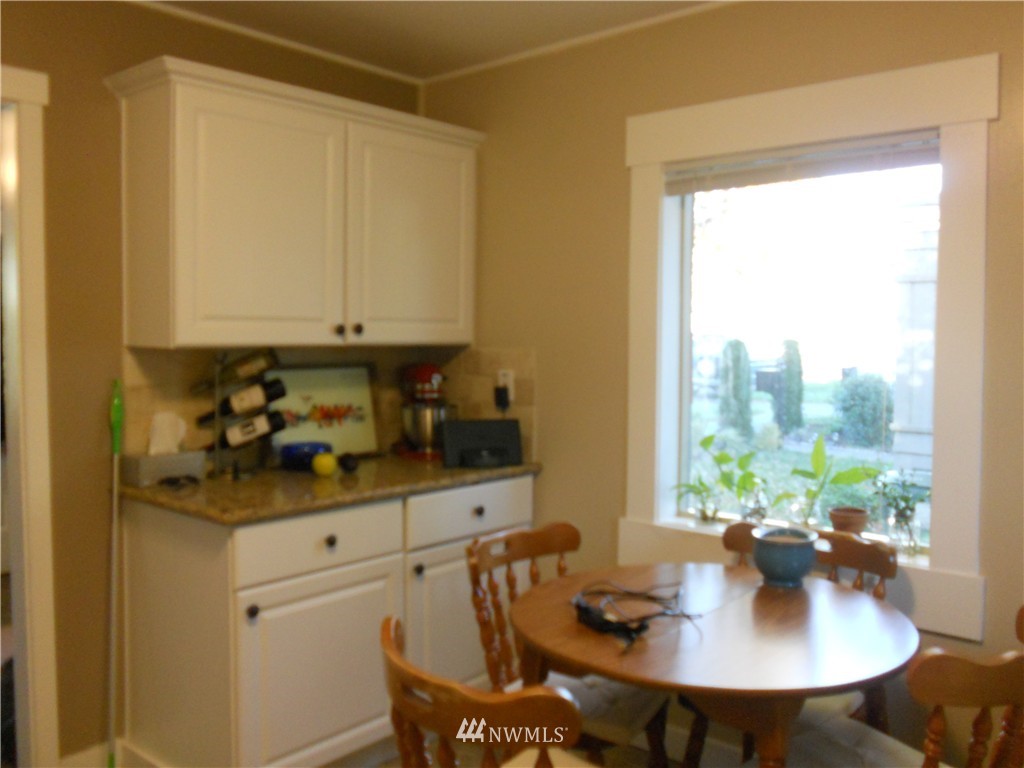 705 North 88th Street Seattle, WA 98103 - Photo 14 of 22 a view of a dining room with furniture and window