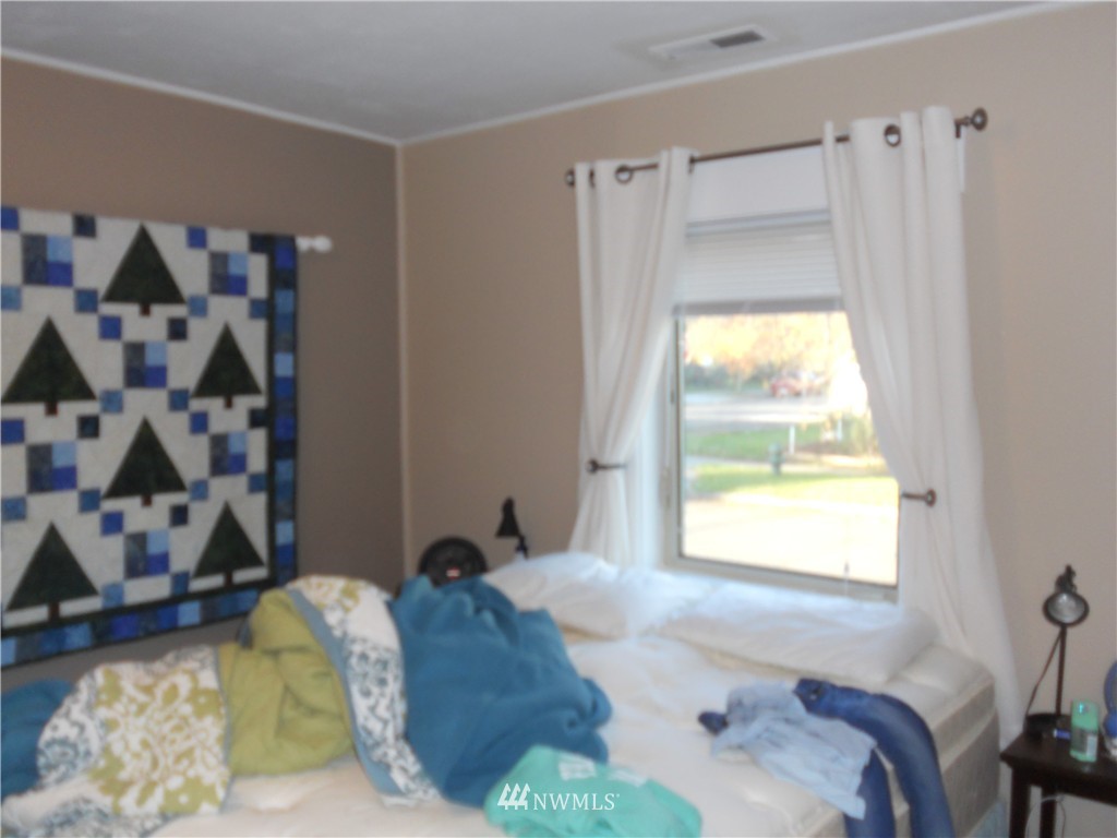 705 North 88th Street Seattle, WA 98103 - Photo 17 of 22 a bedroom with a bed and a window