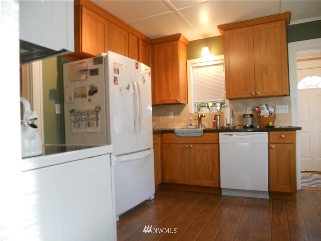 705 North 88th Street Seattle, WA 98103 - Photo 5 of 22 a kitchen with a refrigerator and a stove
