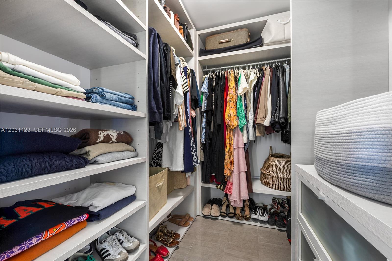 88 Southwest 7th Street, Unit 3208 Miami, FL 33130 - Photo 6 of 16 a view of walk in closet with clothes and shoes