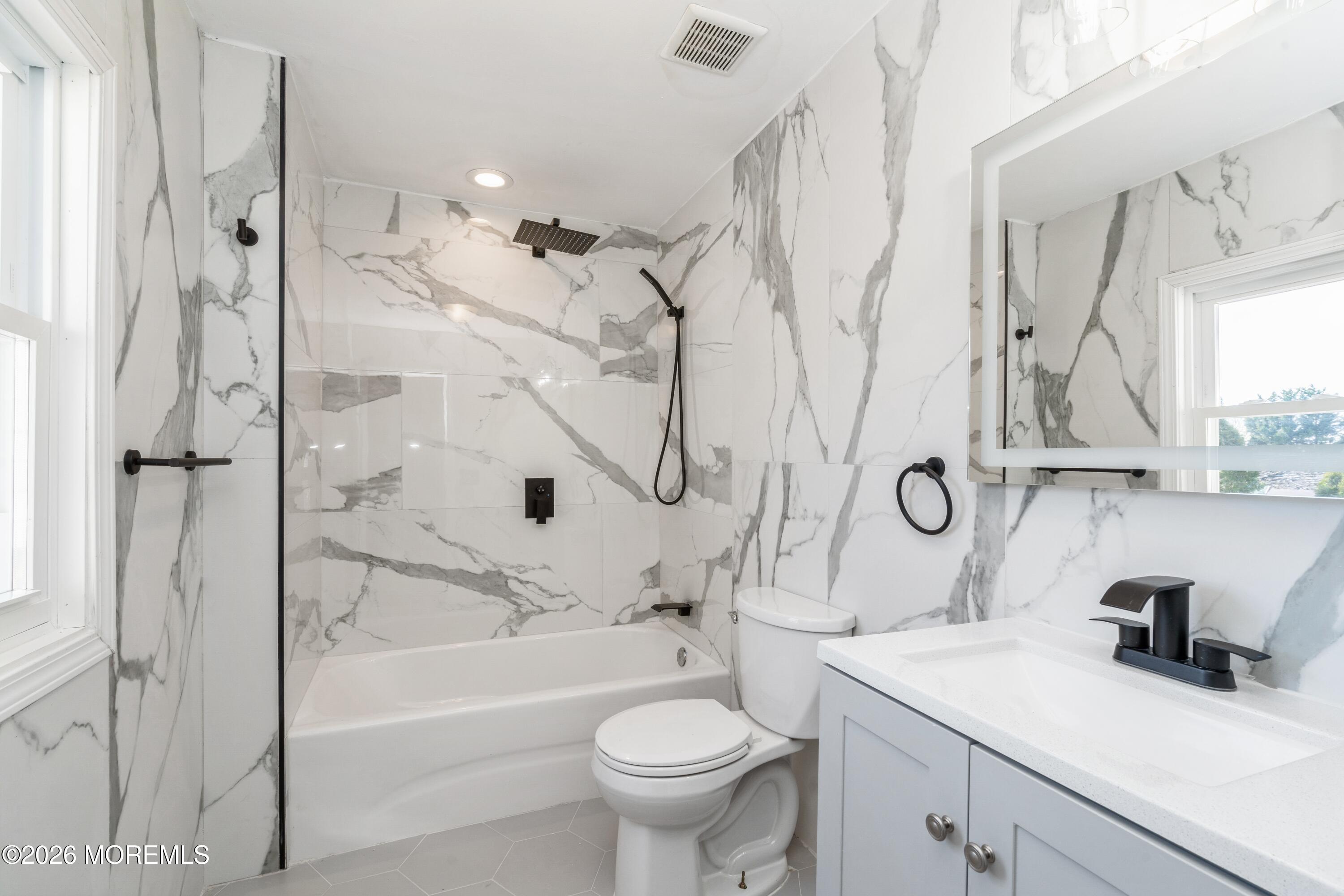 21 Mathiasen Place, Unit A Matawan, NJ 07747 - Photo 11 of 12 a bathroom with a sink a toilet and a bathtub