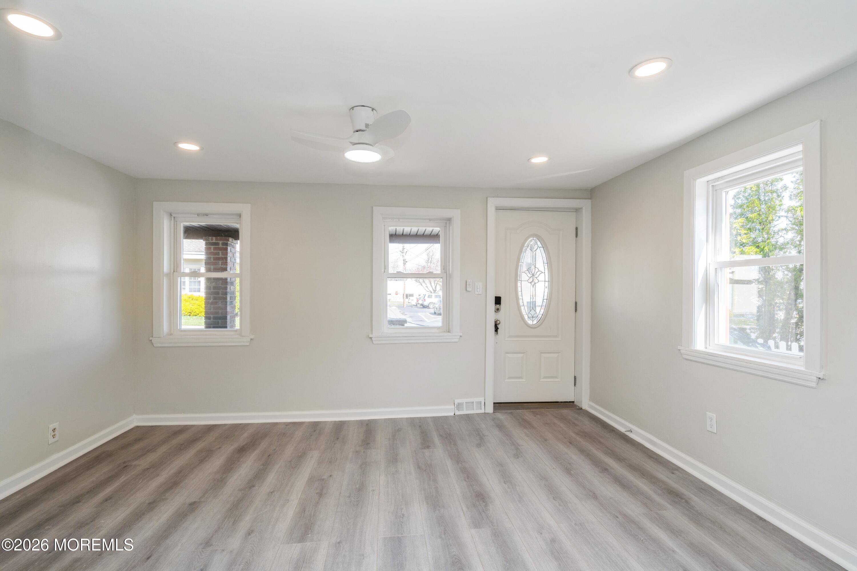 21 Mathiasen Place, Unit A Matawan, NJ 07747 - Photo 2 of 12 a view of room with window and hardwood floor