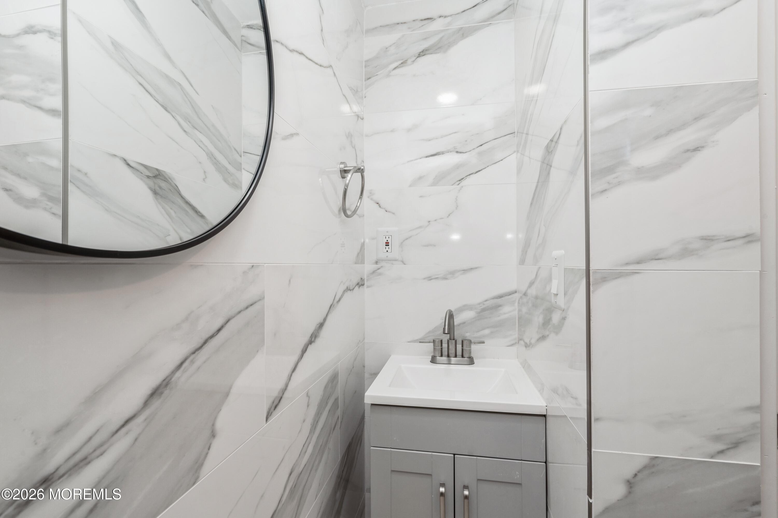 21 Mathiasen Place, Unit A Matawan, NJ 07747 - Photo 7 of 12 a bathroom with a sink and mirror