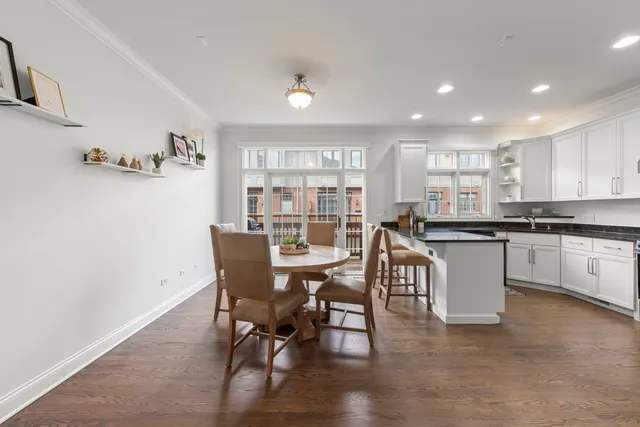 a kitchen with a sink stainless steel appliances and white cabinets