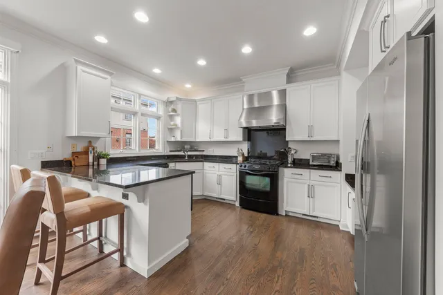 a kitchen with stainless steel appliances granite countertop a stove and a sink