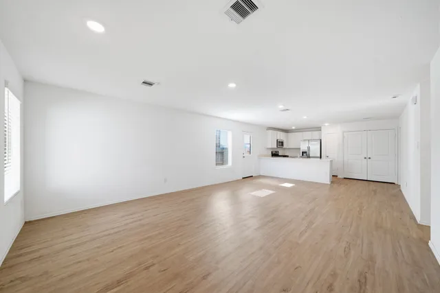 an empty room with a empty space and windows