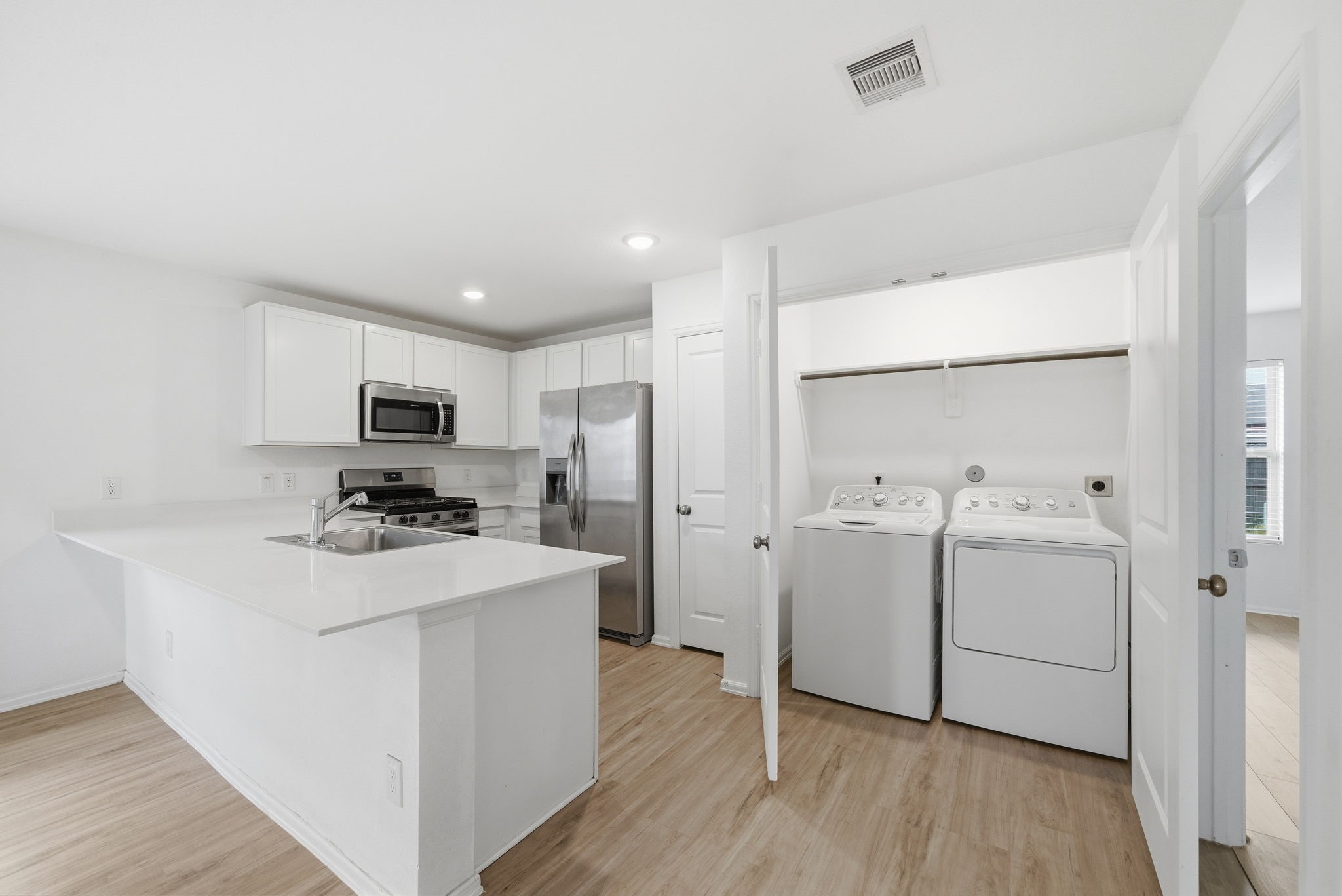 7335 Greenbriar Cyn Lane Katy, TX 77493 - Photo 3 of 10 a kitchen with appliances a sink and cabinets