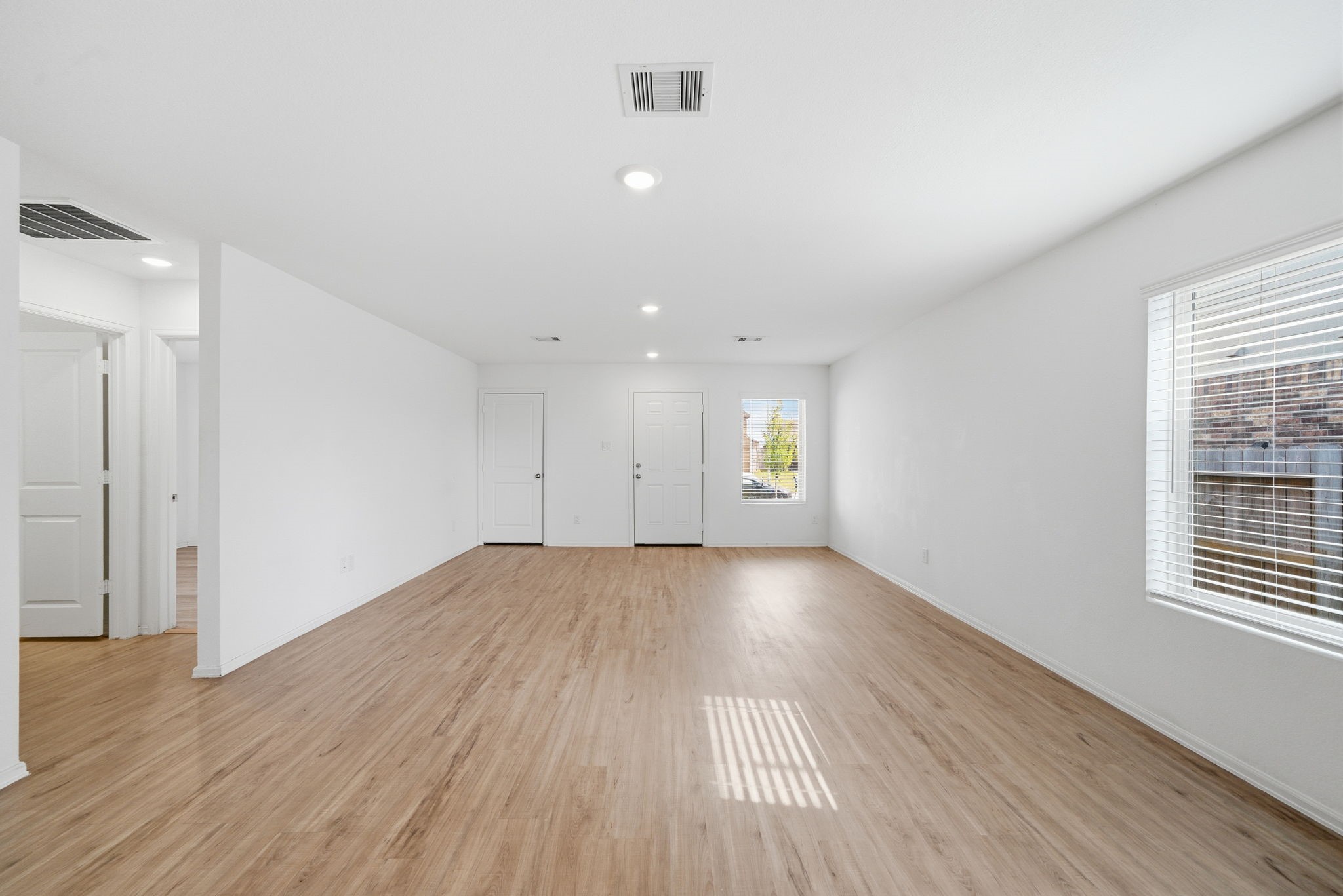 7335 Greenbriar Cyn Lane Katy, TX 77493 - Photo 4 of 10 an empty room with wooden floor and windows
