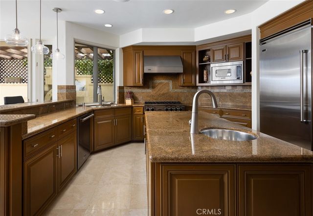 a bedroom with a bed a table and a dresser next to a window