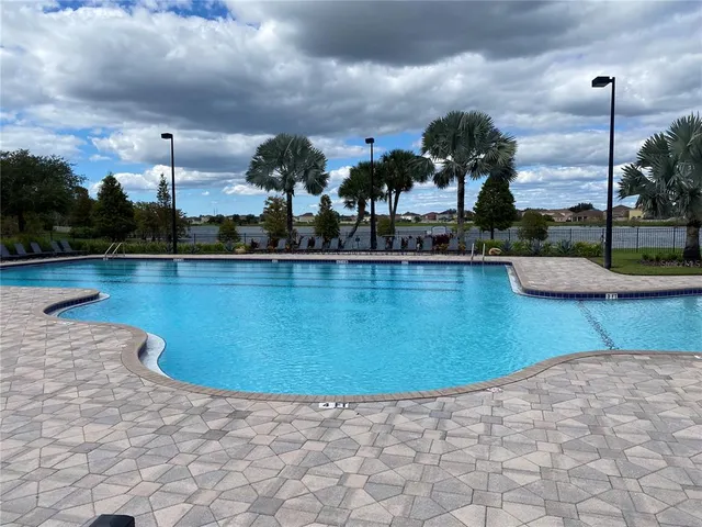 a view of a swimming pool and a chairs