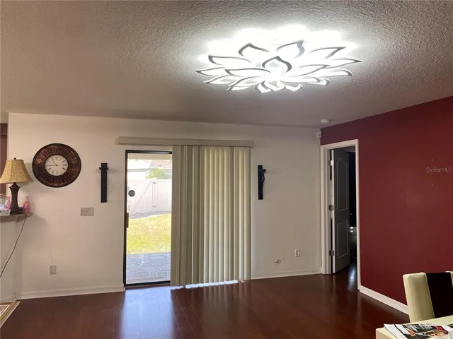 a view of a livingroom with furniture wooden floor and window