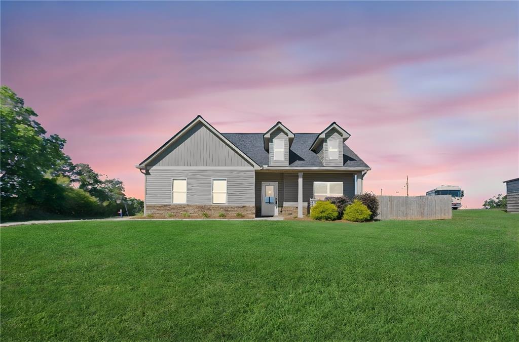 a front view of a house with yard and green space