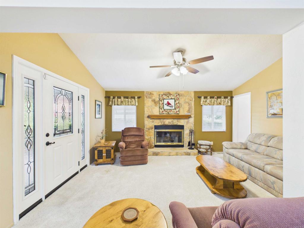 18218 Paradise Mountain Road, Unit 220 Valley Center, CA 92082 - Photo 27 of 48 a living room with furniture ceiling fan and a fireplace