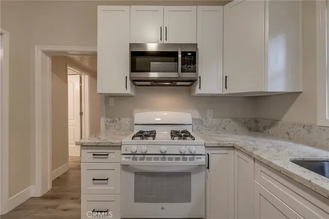 a kitchen with a stove and a microwave