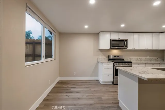 a kitchen with a refrigerator and a sink