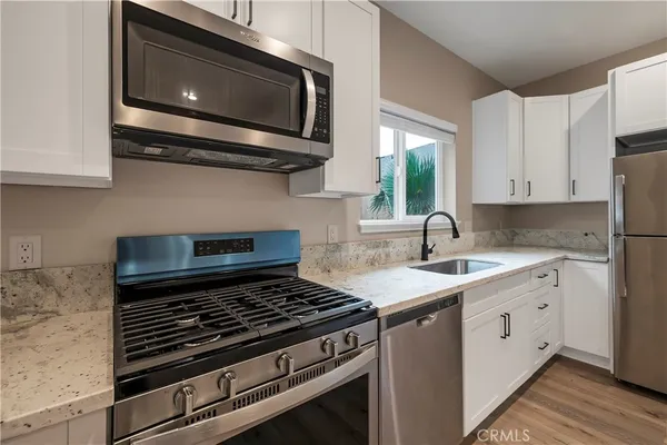 a kitchen with a stove microwave and sink