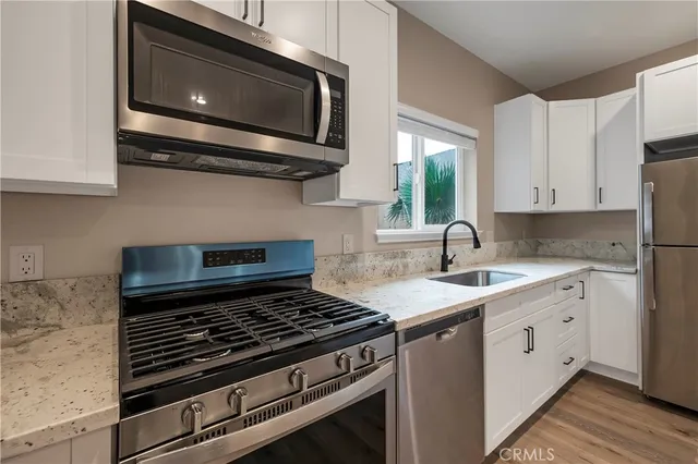 a kitchen with a stove microwave and sink