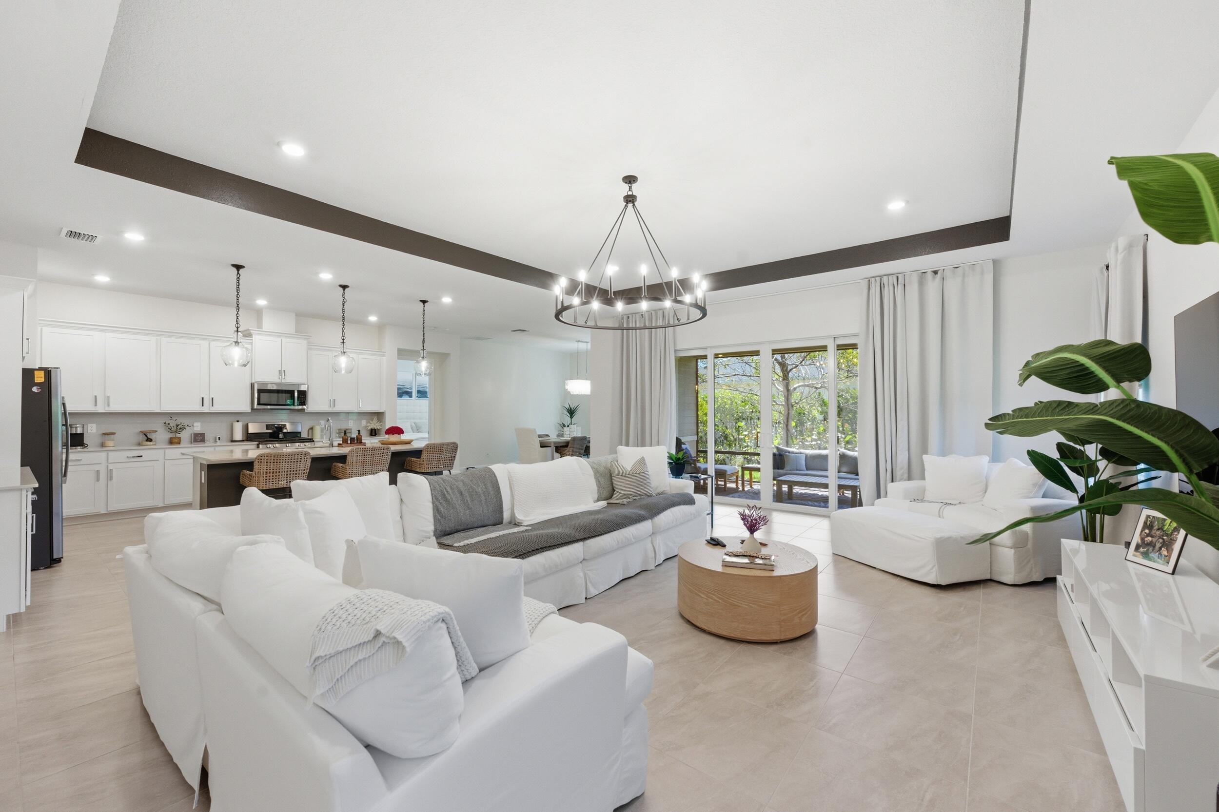 19230 Rolling Acres Road Loxahatchee, FL 33470 - Photo 1 of 58 a living room with furniture and a chandelier