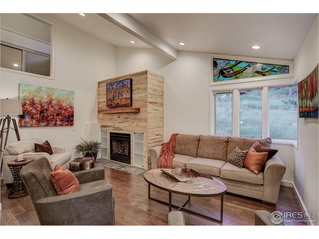765 Pine Brook Road Boulder, CO 80304 - Photo 11 of 37 a living room with furniture a fireplace and a large window