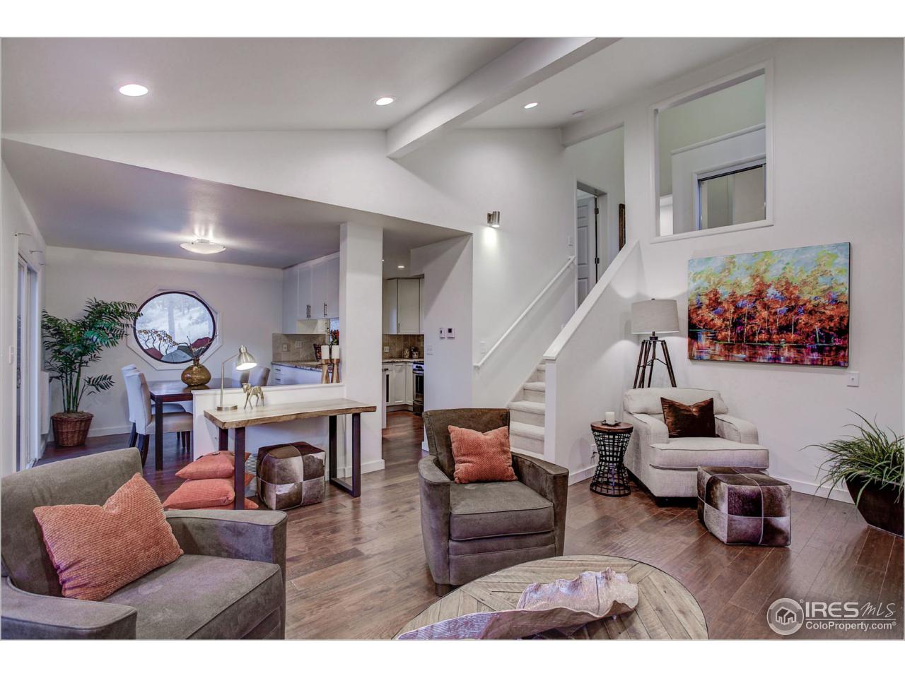 765 Pine Brook Road Boulder, CO 80304 - Photo 12 of 37 a living room with furniture kitchen view and a wooden floor