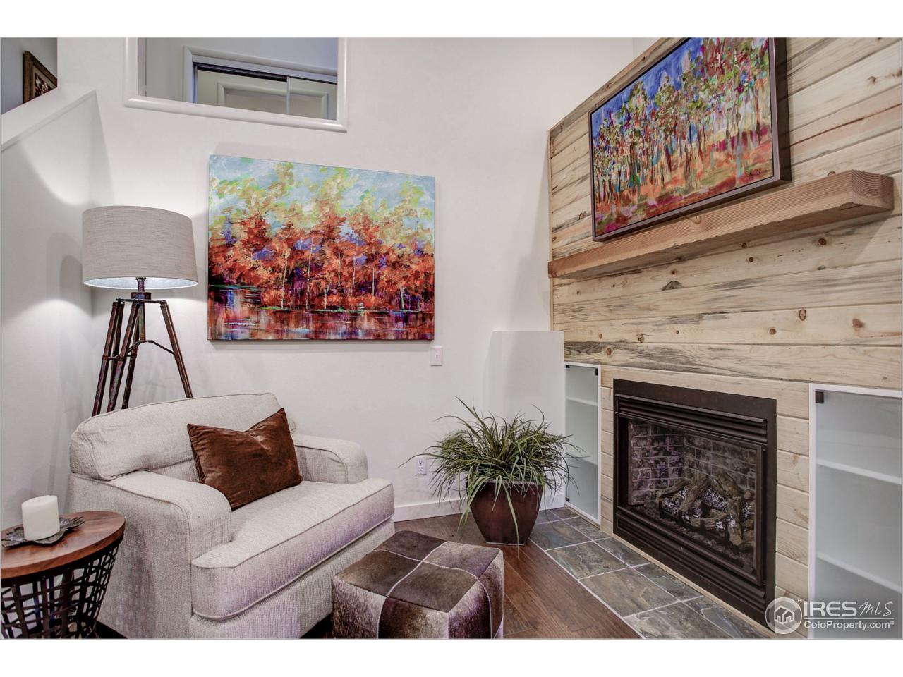 765 Pine Brook Road Boulder, CO 80304 - Photo 13 of 37 a living room with furniture a fireplace and wall paintings