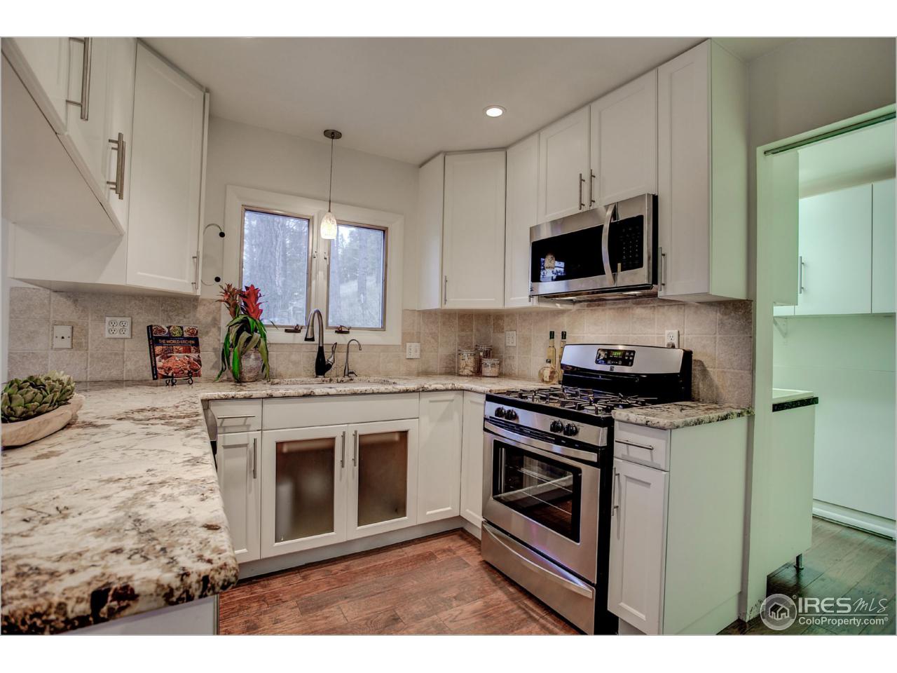 765 Pine Brook Road Boulder, CO 80304 - Photo 17 of 37 a kitchen with stainless steel appliances granite countertop a stove top oven a sink dishwasher and a microwave