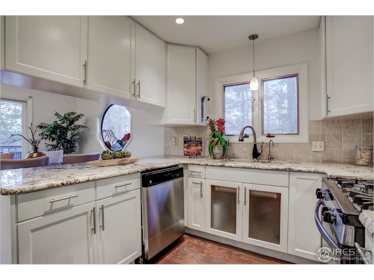 765 Pine Brook Road Boulder, CO 80304 - Photo 18 of 37 a kitchen with granite countertop a sink stainless steel appliances and cabinets