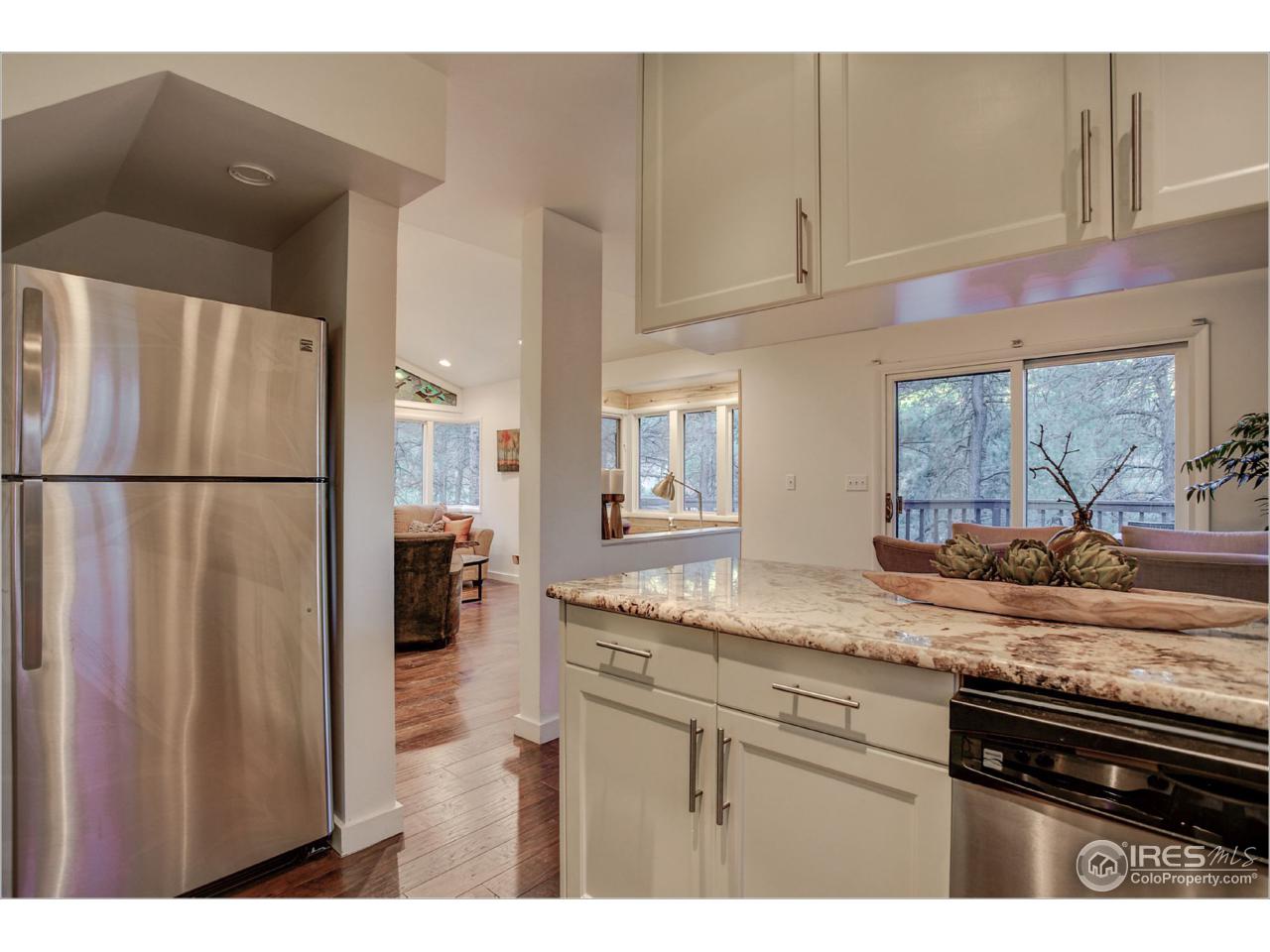 765 Pine Brook Road Boulder, CO 80304 - Photo 19 of 37 a kitchen with stainless steel appliances granite countertop a refrigerator and a sink