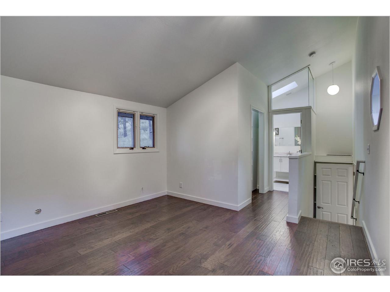 765 Pine Brook Road Boulder, CO 80304 - Photo 21 of 37 a view of empty room with wooden floor
