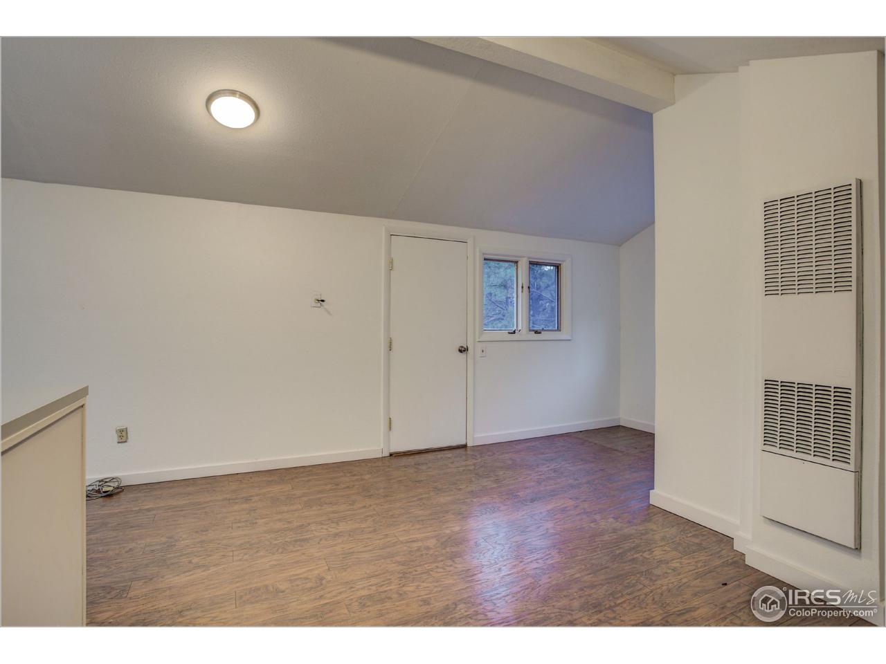 765 Pine Brook Road Boulder, CO 80304 - Photo 35 of 37 a view of an empty room with wooden floor and a window