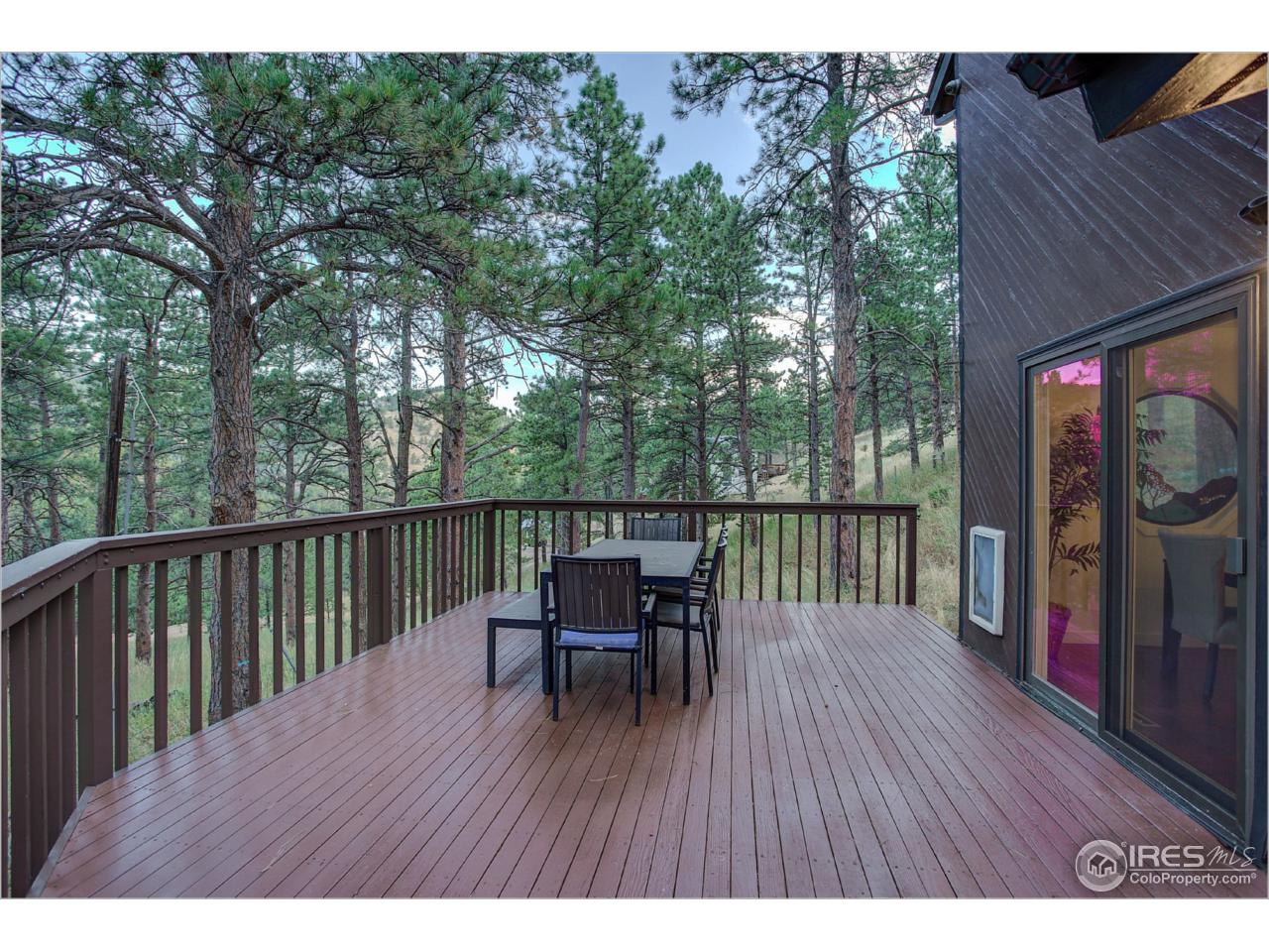765 Pine Brook Road Boulder, CO 80304 - Photo 7 of 37 a balcony with wooden floor table and chairs