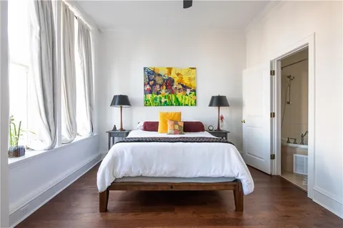 a bedroom with a bed and wooden floor