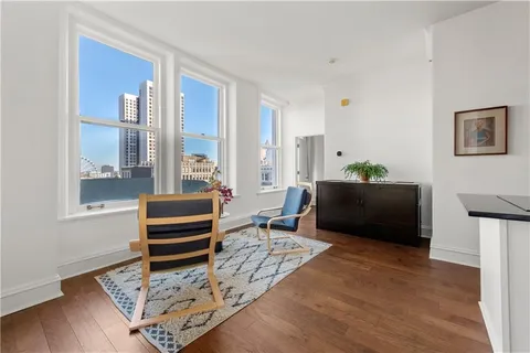 a living room with furniture rug and window