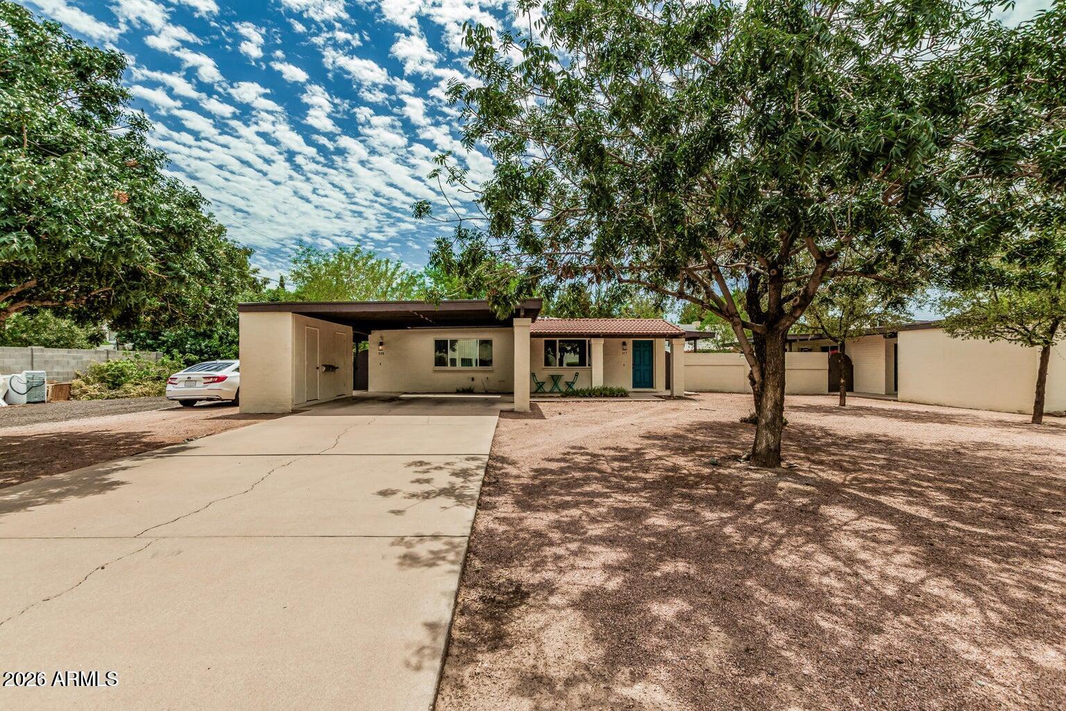 115 West 10th Street Tempe, AZ 85281 - Photo 1 of 19 a front view of a house with a garden and trees