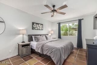 115 West 10th Street Tempe, AZ 85281 - Photo 11 of 19 a bedroom with a large bed and a chandelier