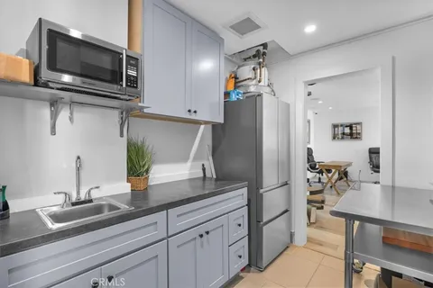 a kitchen with appliances a counter space and cabinets