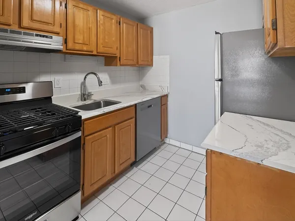 a kitchen with granite countertop cabinets and steel stainless steel appliances