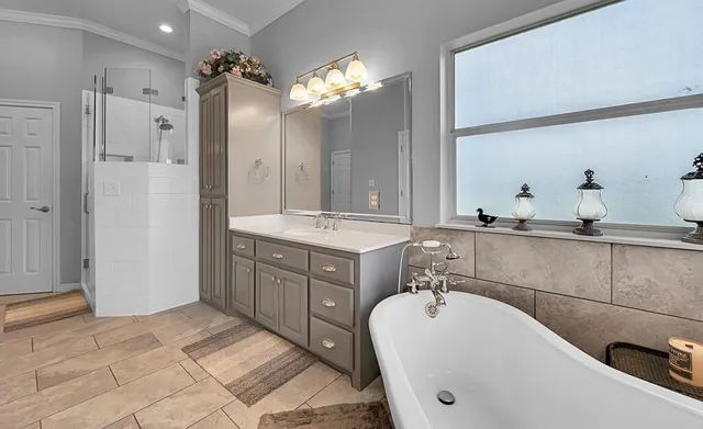a spacious bathroom with a sink double vanity and a shower