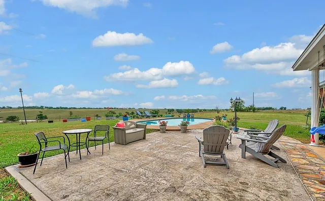 an outdoor sitting area with furniture and garden