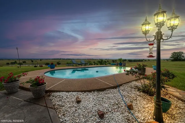 a view of a swimming pool with an outdoor seating
