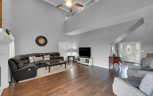 a living room with furniture a fireplace and a flat screen tv