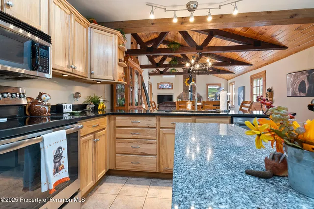 a view of a house with a big yard plants and large trees