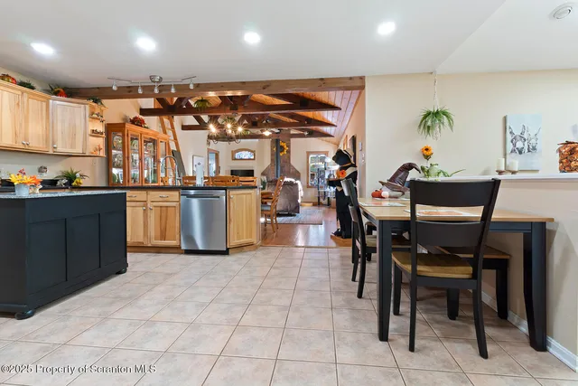 a living room with furniture and a flat screen tv with wooden floor
