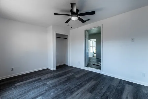 a view of room with hardwood floor and ceiling fan