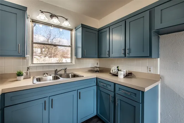 a kitchen with a sink cabinets and window