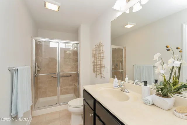 a bathroom with a glass shower door