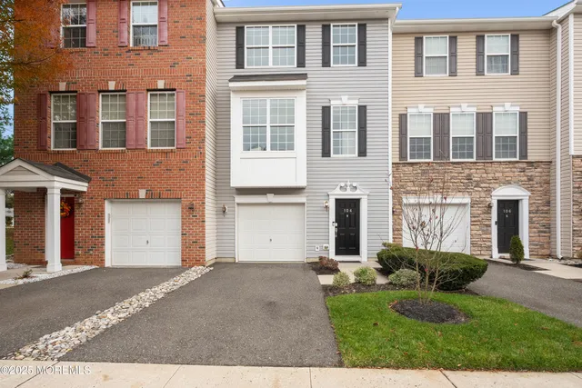 a front view of a house with a garden and plants