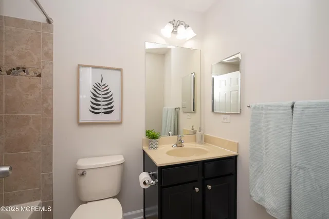 a bath tub sitting next to a white sink and vanity